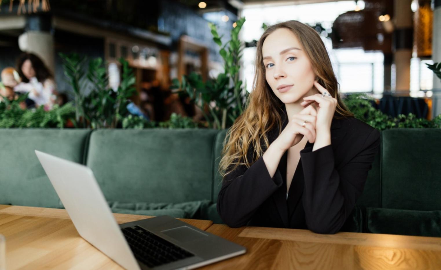 Group of finance professionals collaborating around a conference table with laptops and budget documents